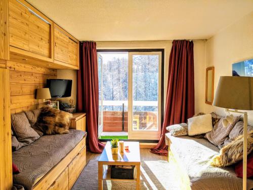 a living room with a cat laying on a couch at COCON VARS LES CLAUX in Vars