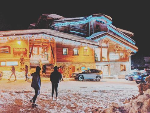 a group of people walking in front of a building at COCON VARS LES CLAUX in Vars