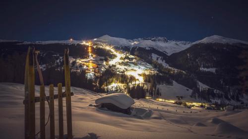 a snow covered mountain at night with a ski resort at Madrisa Lodge in Klosters