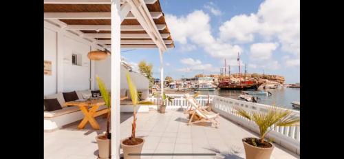 a balcony with a view of a marina with boats at Aqua Vero Seaside Residence in Hersonissos