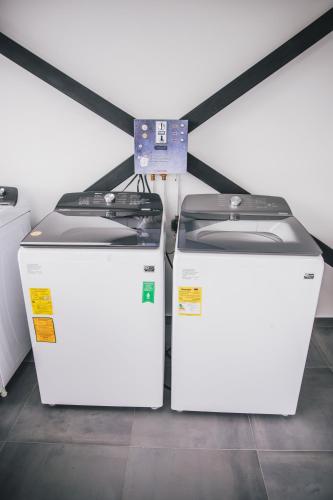 two white refrigerators sitting next to each other at APARTASUITES 21 A in Pereira