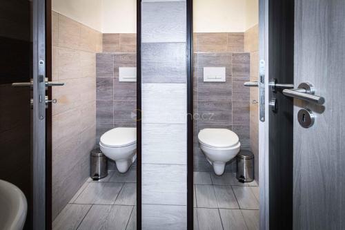 a bathroom with two toilets and a sink at Pension ASTORIA in Klášterec nad Ohří