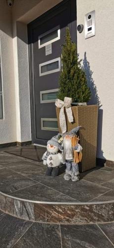 a group of figurines standing in front of a door at Apartments Dora Sveti Martin na Muri in Sveti Martin na Muri