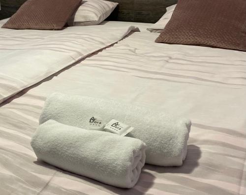 a white bed with towels on top of it at Apartments Dora Sveti Martin na Muri in Sveti Martin na Muri