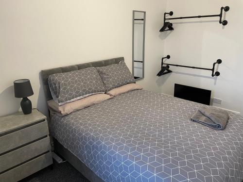 a bedroom with a bed with two lights on the wall at Bedlington apartment in Bedlington