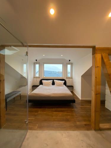 a bedroom with a bed and a large window at Villa Eckhart in Göhren
