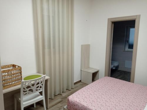 ein Schlafzimmer mit einem Bett, einem Stuhl und einem Heizkörper in der Unterkunft Dimora Pianelle in Crispiano