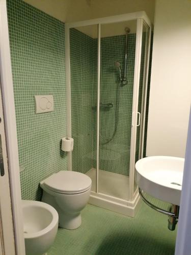 a bathroom with a shower and a toilet and a sink at Poggetto home in Florence