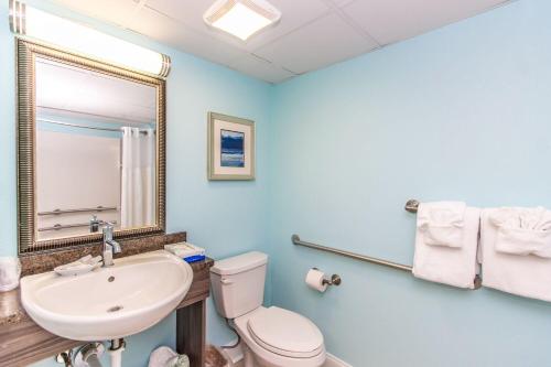 a bathroom with a sink and a toilet and a mirror at Caravelle 506 in Myrtle Beach