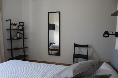 a bedroom with a mirror and a bed and a chair at B&B Casa Valentina in Rome