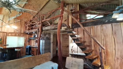 a wooden cabin with a spiral staircase in it at Cabañas Rústicas Pucón Río Trancura in Pucón