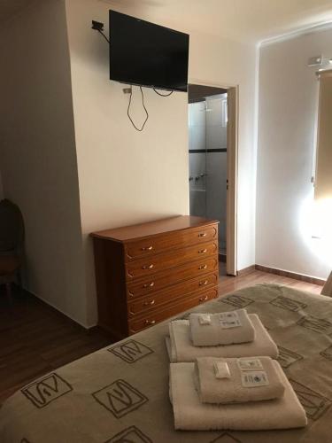 a bedroom with a dresser and a television on the wall at Casablanca in Victoria
