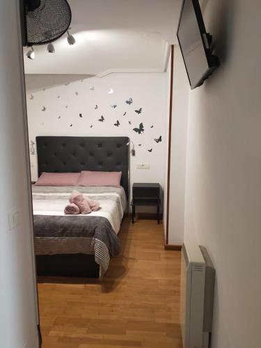 a bedroom with a bed with bats on the wall at Ático tipo Loft centro de Mugardos in Mugardos