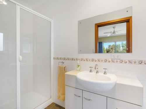 a white bathroom with a sink and a shower at Breeze on Scenic - 7 Scenic Way, Carrickalinga in Carrickalinga