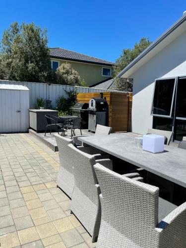 a patio with a table and chairs and a grill at Cromwell Getaway in Cromwell