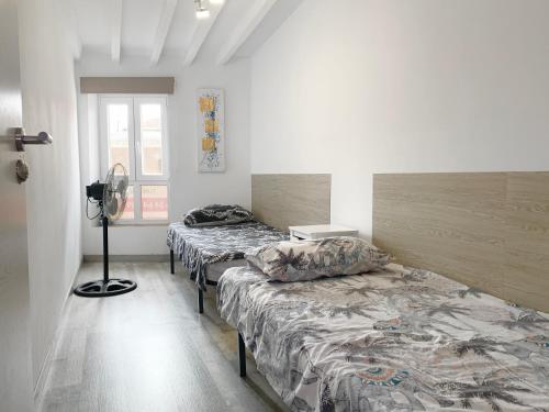 a room with three beds and a fan at Casa Ekaterina de Novelda in Novelda