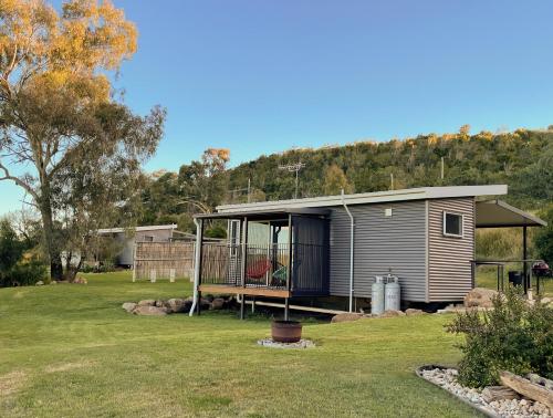 a tiny house with a porch in a yard at Kiambram Country Cottages in Gowrie Little Plain