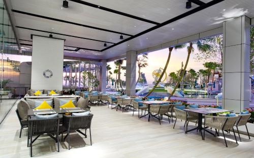 a rendering of a restaurant with tables and chairs at Grande Centre Point Pattaya in Pattaya Central