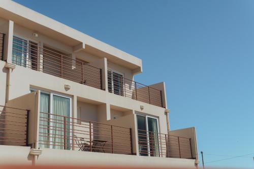 un edificio con balcones en un lateral en Solana - Apart Hotel & Club de Tenis en Santa Clara del Mar