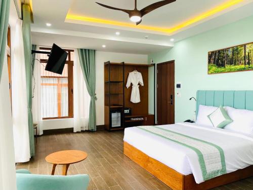 a bedroom with a bed and a tv in it at Lasol Boutique Hotel in Da Lat