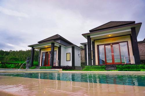 a house with a pool in front of it at Bali Astetic Villa and Hot Spring in Kintamani