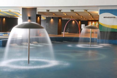 a pool with two fountains in a swimming pool at VS Hotel in Manila