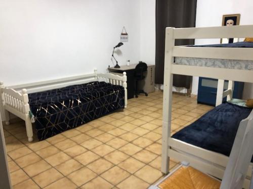 a bedroom with two bunk beds and a desk at Hoche in Coursan