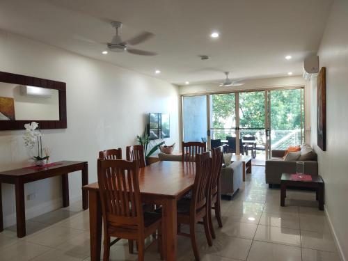 a dining room and living room with a table and chairs at Beachfront Beauty! in Mission Beach