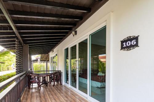 a porch of a house with a table at Nature Line Resort in Khanom