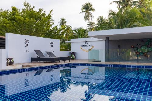 a villa with a swimming pool in a resort at Nature Line Resort in Khanom