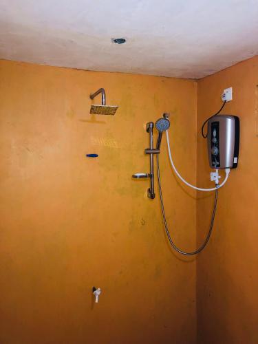 a bathroom with a shower with a tv on the wall at Sigiri Lion Eco Palace in Sigiriya
