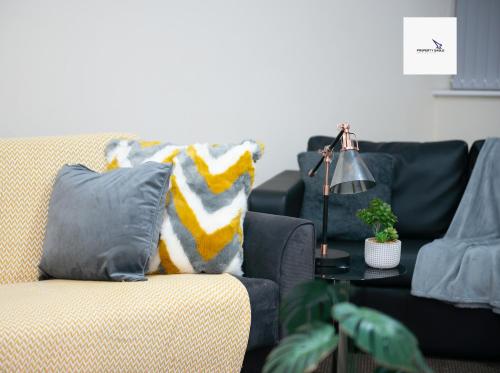 a living room with a couch and a table at 5Blythe House Apartments Brierley Hill in Birmingham