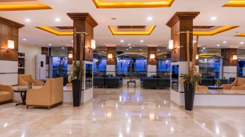 a lobby of a hotel with couches and chairs at Armas Labada in Kemer