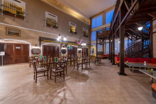 a restaurant with tables and chairs in a room at Armas Labada in Kemer