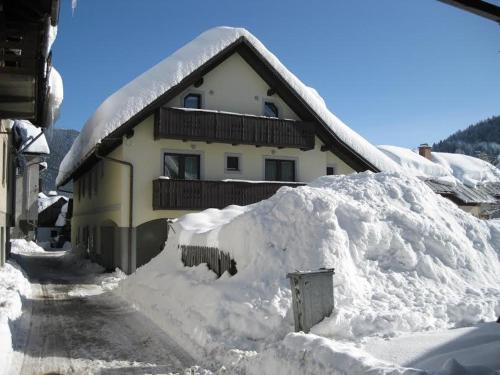 
a snow covered building with a view of a city at Rooms Cvitar - Center in Kranjska Gora
