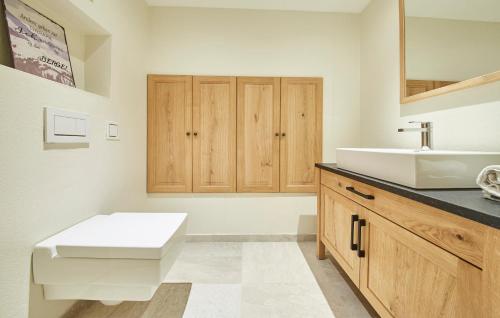 a bathroom with a white sink and a counter at Chalet Tannenbaum in Saalbach Hinterglemm