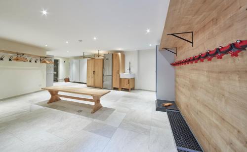 a living room with a bench and a sink at Chalet Tannenbaum in Saalbach Hinterglemm