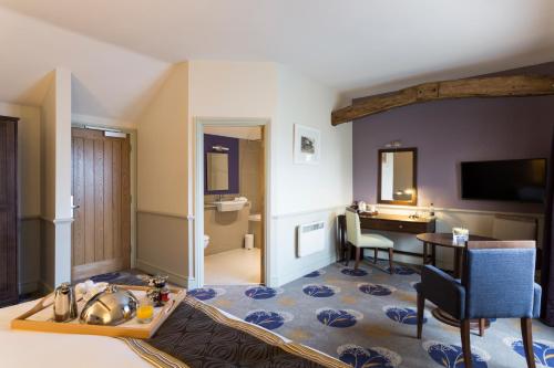 a hotel room with a desk and a room at Quy Mill Hotel & Spa, Cambridge in Cambridge