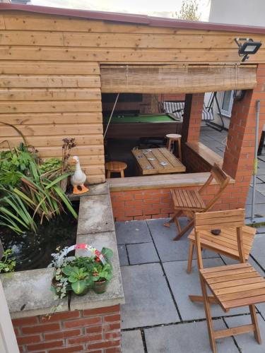 a backyard patio with a koi pond and a wooden shed at Norfolk Guest House in Bristol