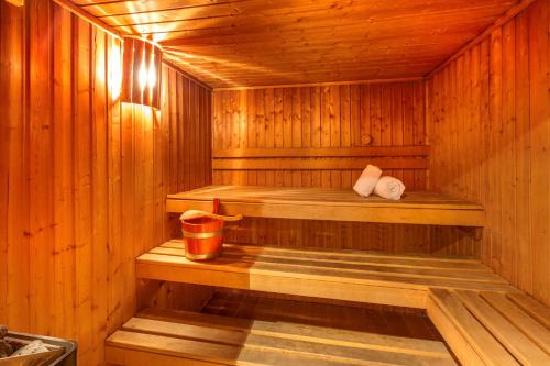 a sauna with a trash can and a bucket in it at Best Western Plus Hotel Villa D'est in Strasbourg