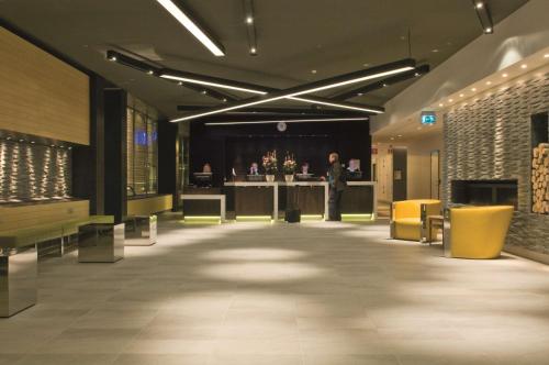a man standing in the middle of a lobby at Radisson Blu Waterfront Hotel, Stockholm in Stockholm