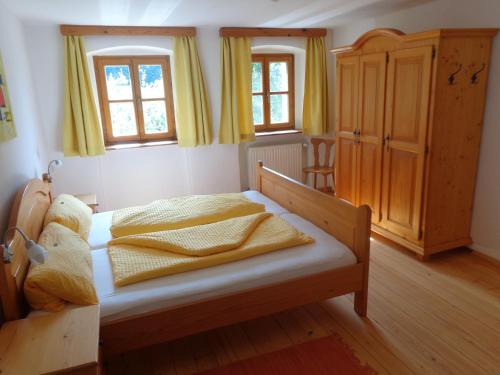 a bedroom with a bed with yellow curtains at Biohof Stadler in Neustift im Mühlkreis