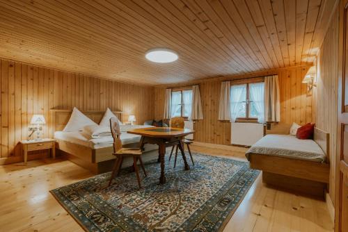 a room with a bed and a desk and a table at Gästehaus Ilishof in Schruns