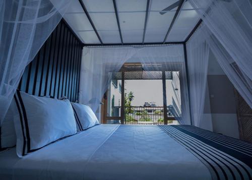 a bedroom with a bed with a view of a balcony at Temptation in Hikkaduwa