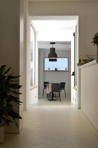 a hallway leading to a dining room with a table at Petit Hotel in Lido di Camaiore