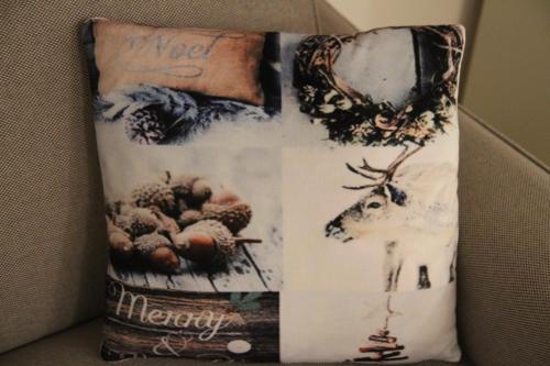 a pillow with a picture of a deer and a book at homesweethome venice in Venice