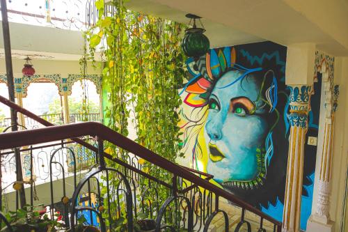 a painting on a wall of a building with flowers in it at Dreamyard Udaipur in Udaipur