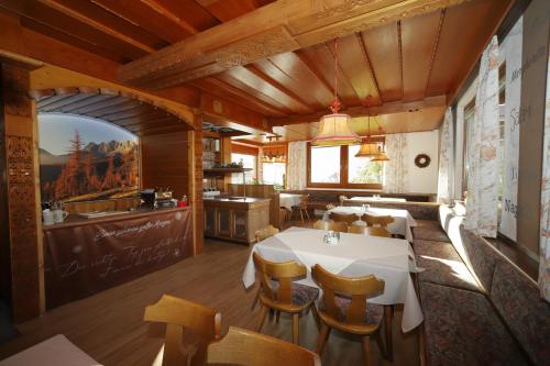 a kitchen and dining room with a table and chairs at Hotel-Café Perner in Schladming