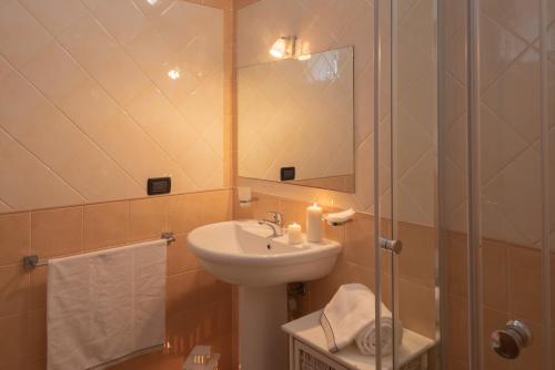 bagno con lavandino e doccia con specchio di Residence Le Fontane a Villasimius