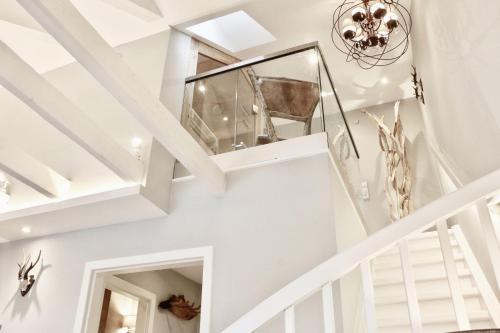 a staircase in a house with white walls and ceilings at HOME Suites Maisonette mit Sauna in Braunlage